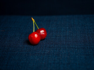 Fresh fruits of red cherries on a blue background
