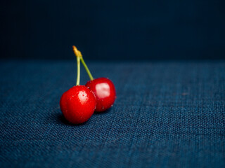 Fresh fruits of red cherries on a blue background