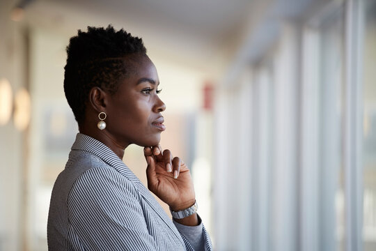 Side View Of Confident Female Entrepreneur Looking Away While Standing At Workplace