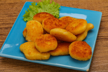 Fried chicken nuggets served salad leaves