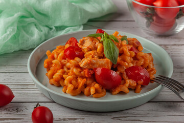 Pasta with cherry tomatoes and basil. Italian food. Italian Cuisine. Homemade food. The concept of tasty and healthy food.