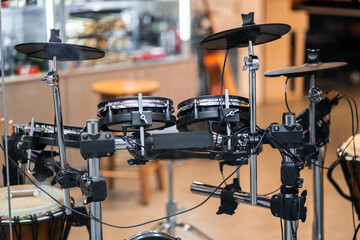 Fototapeta na wymiar Electronic modern drum kits in a small music shop. Musical instruments, hobbies and music concept - electronic drum kit. horizontal