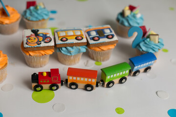 holiday cupcakes in the form of a locomotive. cupcakes with cream for a child's birthday