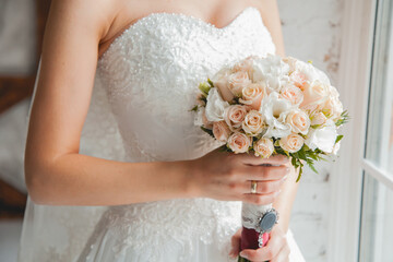 Wedding bouquet in the hands of the bride