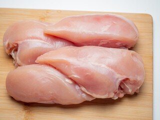 Fresh chicken fillet on a wooden board