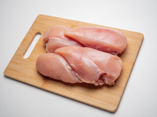 Fresh chicken fillet on a wooden board