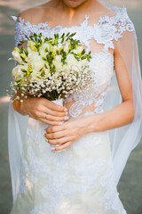 Wedding bouquet in the hands of the bride