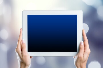 Holding a digital tablet with a blank screen