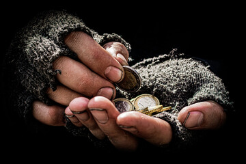 The beggar's hands are dirty, a few cents in the palms. Hands in old torn gloves, poverty, despair...