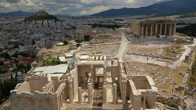 Aerial drone video of Acropolis main entrance gateway as seen on a beautiful cloudy spring morning, Athens, Attica, Greece