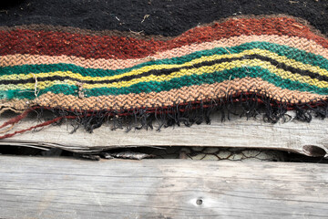 Old folk rug on a wooden background, copy space.