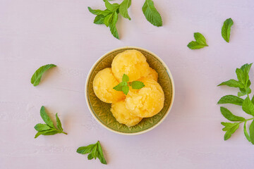 Yellow watermelon sorbet with mint leaves
