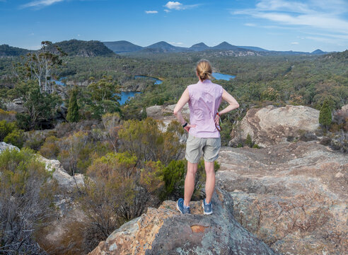 Woman Standing On Rock By Forest