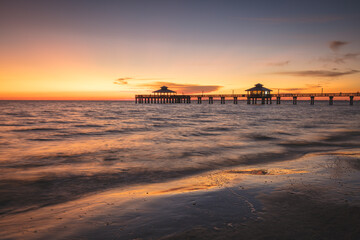 USA, Florida, Fort Myers Beach, Pier in sea at sunset