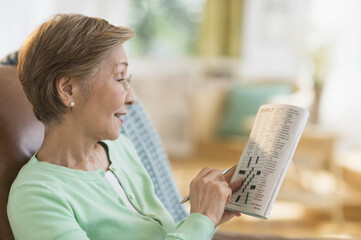 Senior woman doing crossword puzzle