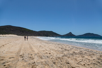 Australia, New South Wales, Sydney. Pacific ocean. Fingal Bay. A couple in love far away.