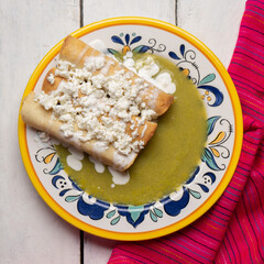 Mexican drowned flautas with green sauce also called 
