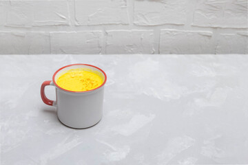 Mug of hot healthy turmeric golden milk