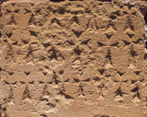 carved cross on the wall of the church