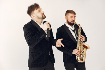 Man with a microphone. Singer in studio. Musician with saxophone. Music band.