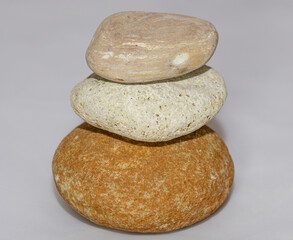 Fototapeta na wymiar Scattered sea pebbles. Smooth stones isolated on white background 