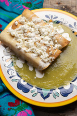 Mexican drowned flautas with green sauce also called 