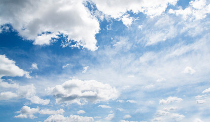 Naklejka na ściany i meble White clouds on a background of blue sky. Banner format