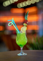 Summer time drinks glass of lemon juice lemonade on wooden desk in blur background