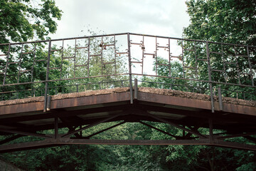 A concrete pedestrian bridge with steel beams bottom view