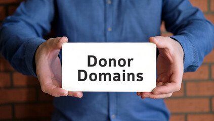 Donor domain - seo concept for site in the hands of a young man in a blue shirt