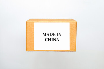 Cardboard box with sticker and text label Made in China on white background with copy space. The concept of gifts in a box form and online delivery of goods at home