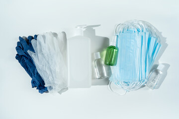 Set of protecting disposable filtering face masks, gloves, sanitizers for hands on white...