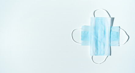 Medical background for a banner with protective masks folded in a cross on a white background.