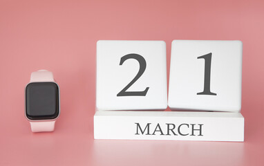 Modern Watch with cube calendar and date 21 march on pink background. Concept spring time vacation.