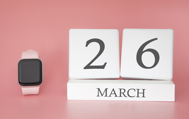 Modern Watch with cube calendar and date 26 march on pink background. Concept spring time vacation.