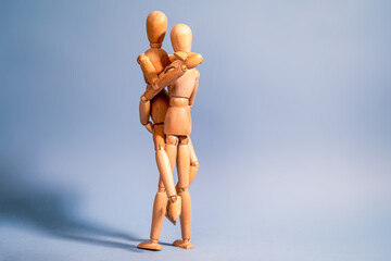 Cute couple posing together. He is sweeping her up in his arms.