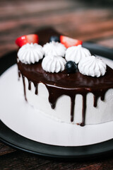 cheesecake cake cut with chocolate on a black plate