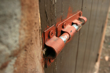 close up of an old wooden door with a lock