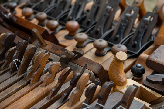 An Angular, Slightly Overhead Perspective Of A Collection Vintage Woodworking Planes On A Table