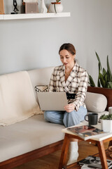 A business woman who has a video call with a colleague working online from home in a cozy atmosphere. The concept of working remotely from home. working remotely.
