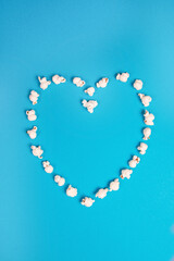 Romantic heart made out of popcorn on a blue background