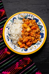 Mexican picadillo with rice on dark background
