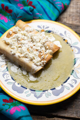 Mexican drowned flautas with green sauce also called 