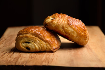 two pain du chocolat on a board