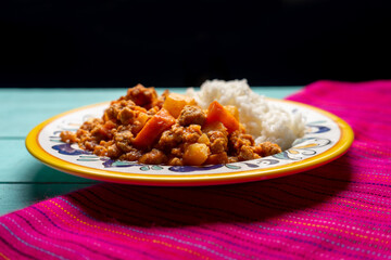 Mexican picadillo with rice on turquoise background