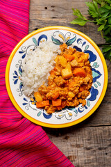 Mexican picadillo with rice on wooden background