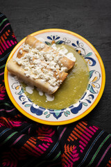 Mexican drowned flautas with green sauce also called 