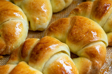 Argentine croissants, medialunas de Manteca over silicon pastry mat close-up
