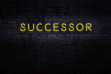 Night view of neon sign on brick wall with inscription successor