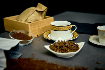 Preparation of a delicious Colombian café traditionally filtered with fabric. On the table implements necessary for its preparation and how to serve it.